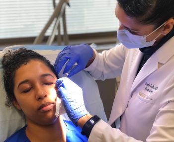 Dr. Pooja Sodha performing procedure on patient